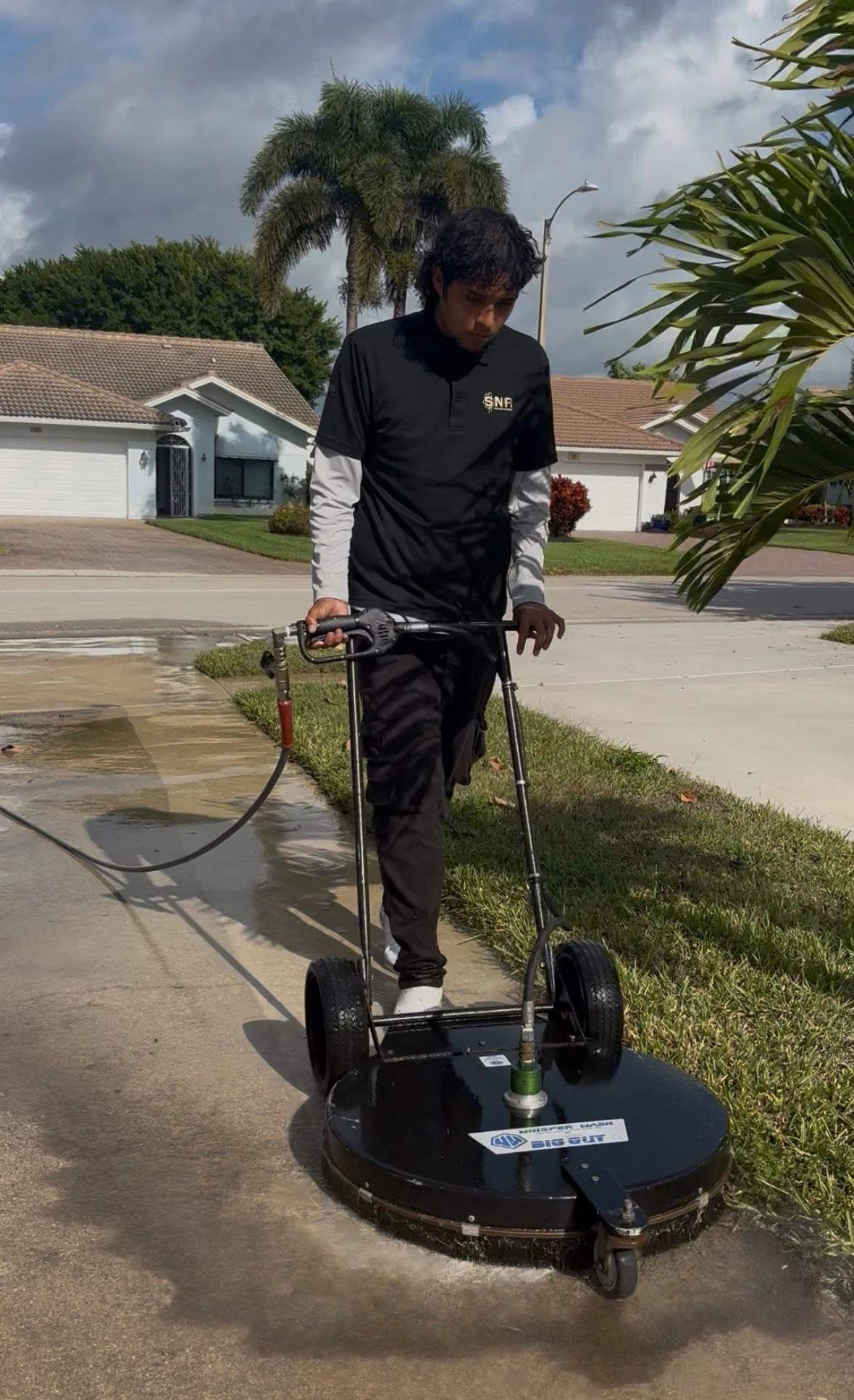 Paver driveway after SNR pressure washing, with tire marks and dirt fully removed