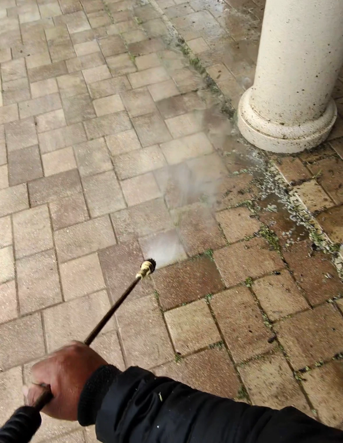 Long residential driveway after SNR pressure washing, with discoloration removed