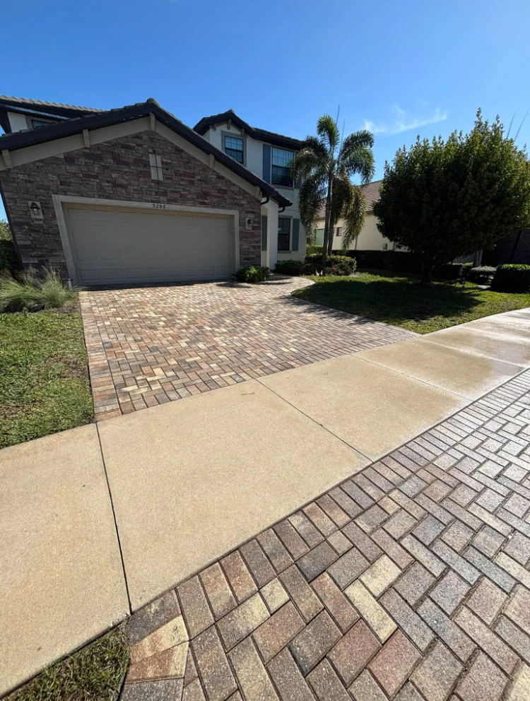 Driveway after SNR pressure washing, showing a bright, freshly cleaned surface