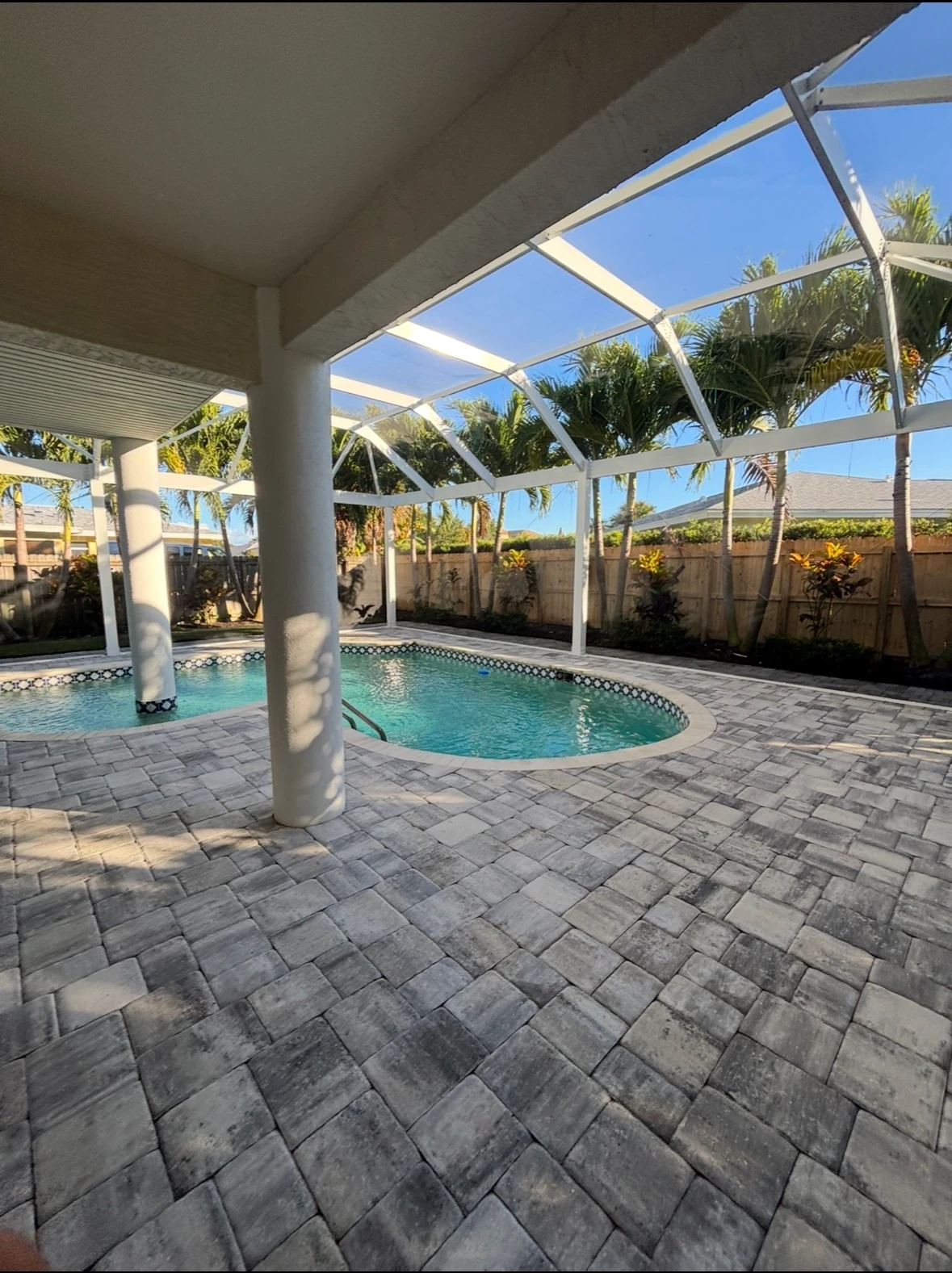 Paver pool deck after SNR pressure washing, with mildew and algae removed